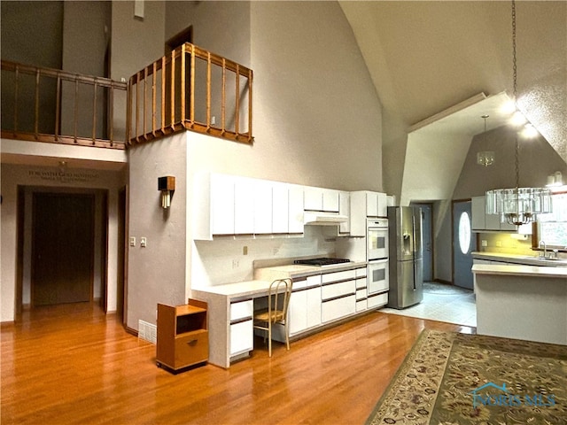 kitchen featuring white cabinetry, light hardwood / wood-style flooring, and a chandelier