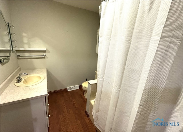 bathroom with vanity, toilet, wood-type flooring, and a shower with shower curtain