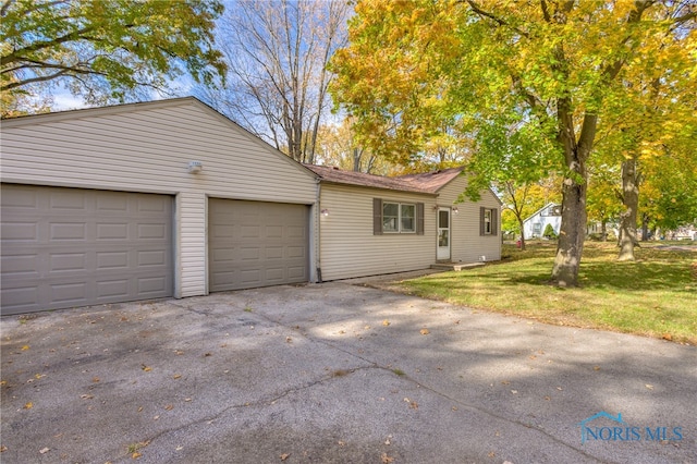 exterior space featuring a front yard and a garage