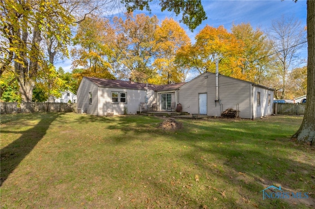 rear view of house featuring a yard