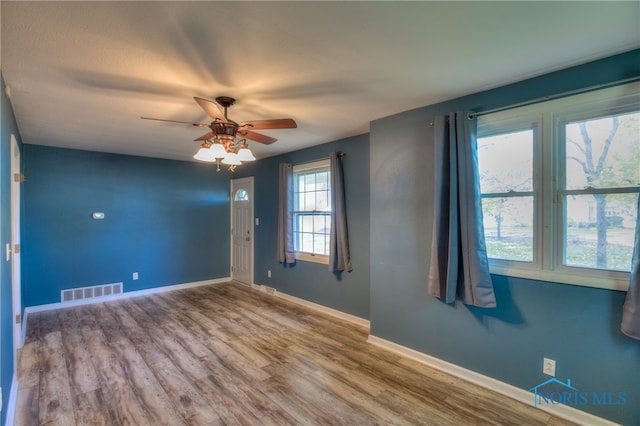 empty room featuring hardwood / wood-style floors and ceiling fan