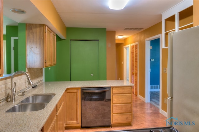 kitchen featuring decorative backsplash, black dishwasher, kitchen peninsula, sink, and white refrigerator