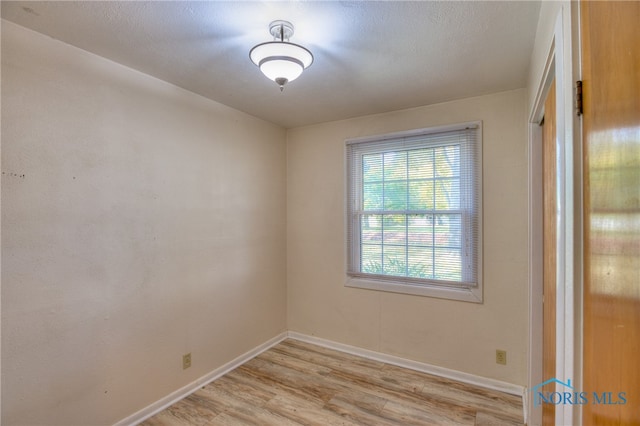 unfurnished room featuring light hardwood / wood-style floors