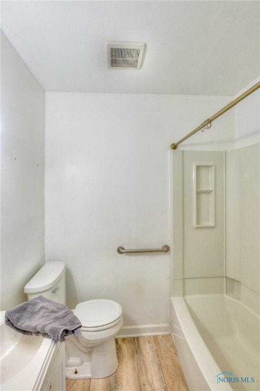 full bathroom with toilet, bathing tub / shower combination, vanity, and wood-type flooring