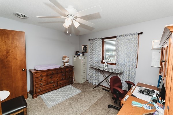 carpeted office with ceiling fan