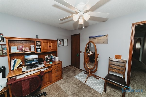 office space with light carpet and ceiling fan