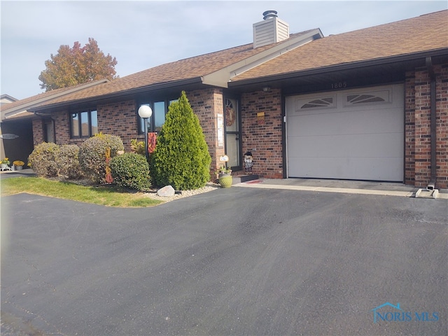 single story home featuring a garage