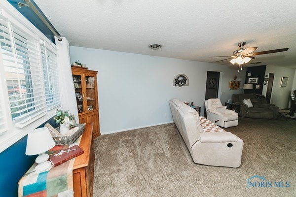 living room with ceiling fan and carpet floors