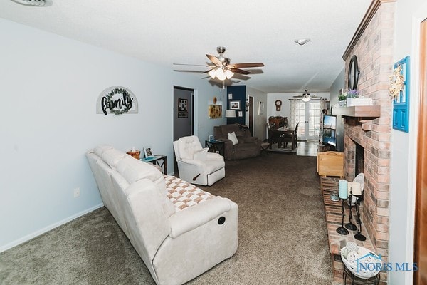 living room featuring ceiling fan, carpet flooring, and a fireplace