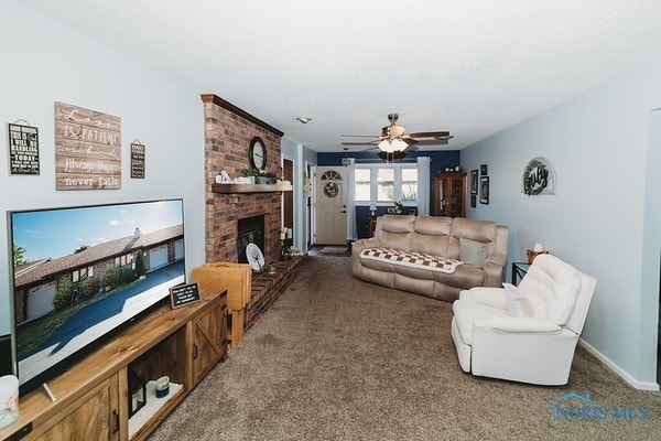 carpeted living room featuring a fireplace and ceiling fan