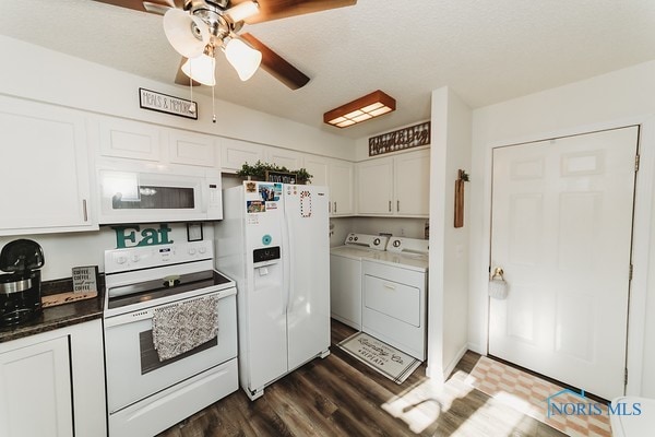 kitchen featuring ceiling fan, white cabinetry, washing machine and clothes dryer, dark wood-type flooring, and white appliances