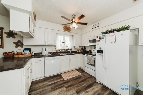 kitchen featuring sink, dark hardwood / wood-style flooring, white cabinets, white appliances, and ceiling fan