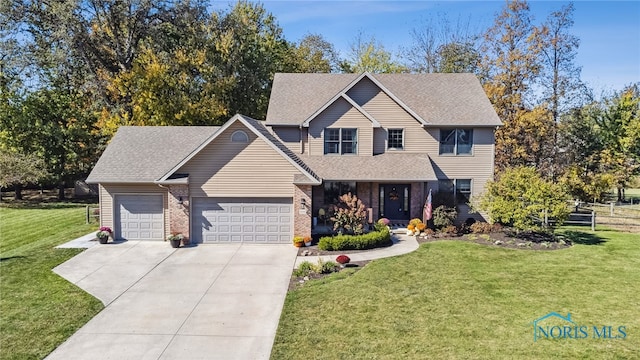 view of property featuring a garage and a front lawn