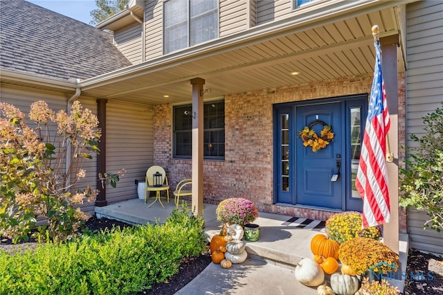 view of exterior entry with covered porch