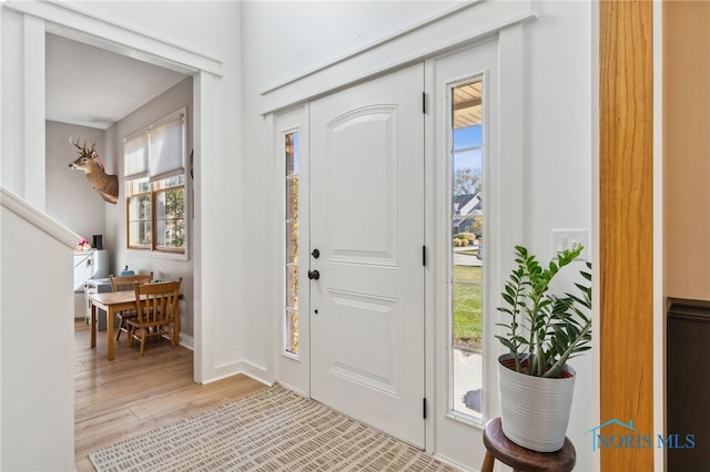 foyer entrance with light hardwood / wood-style floors