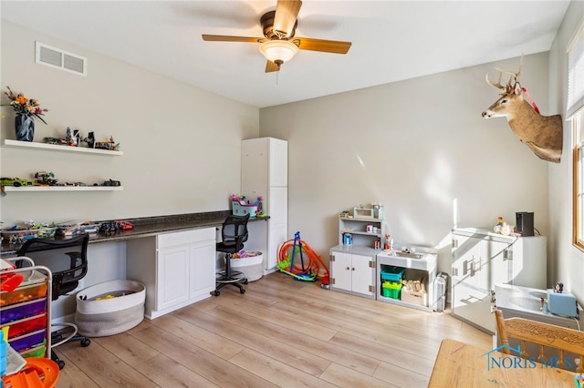 interior space with light wood-type flooring and ceiling fan