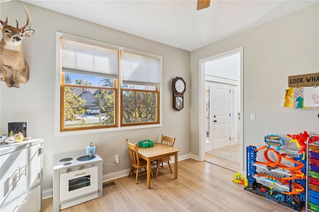 recreation room with light hardwood / wood-style flooring and ceiling fan