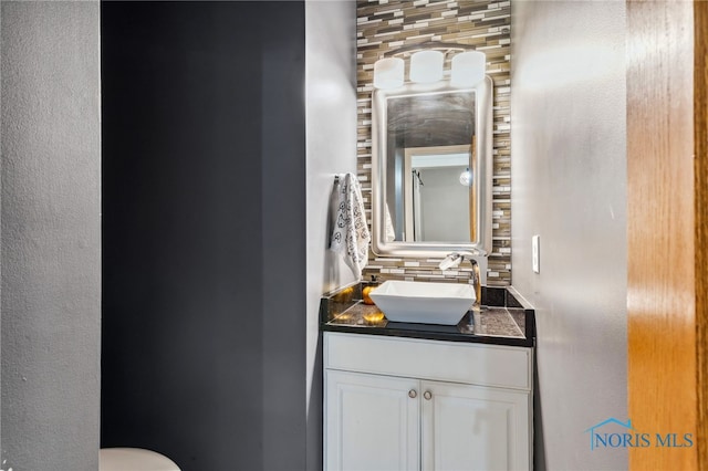 bathroom with vanity and tasteful backsplash