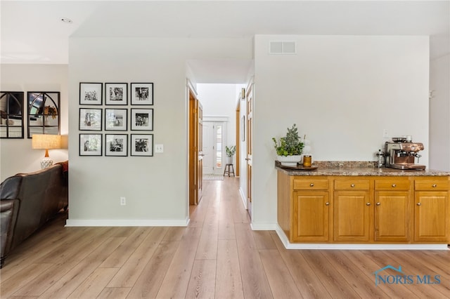 corridor with light hardwood / wood-style floors