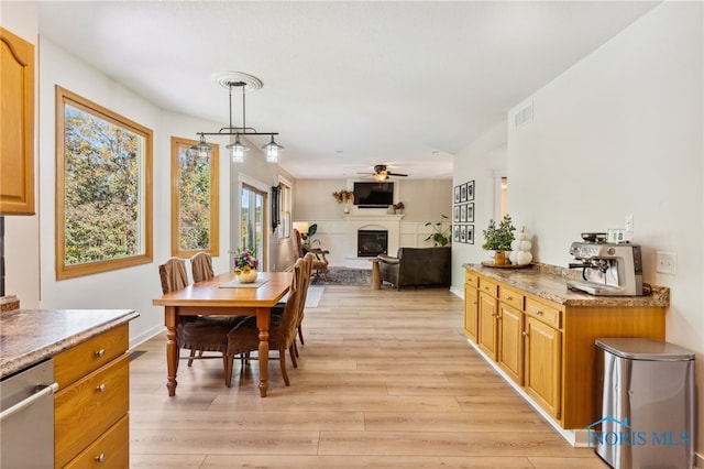 dining space featuring light wood-type flooring and ceiling fan