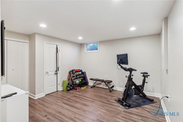 workout area with hardwood / wood-style floors