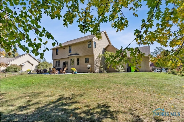 rear view of house featuring a patio and a lawn