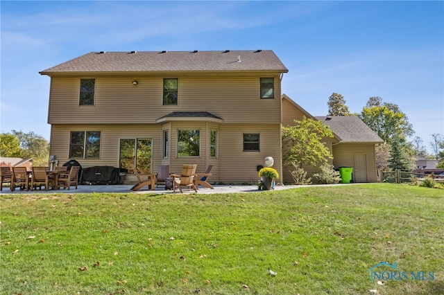 back of property featuring a yard and a patio