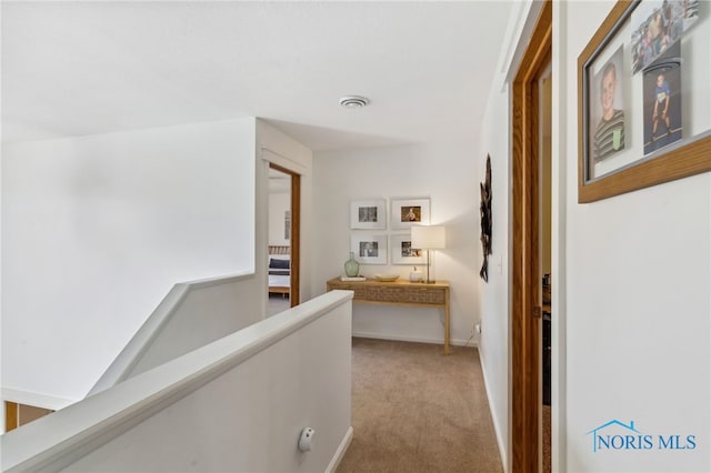 hallway featuring light carpet