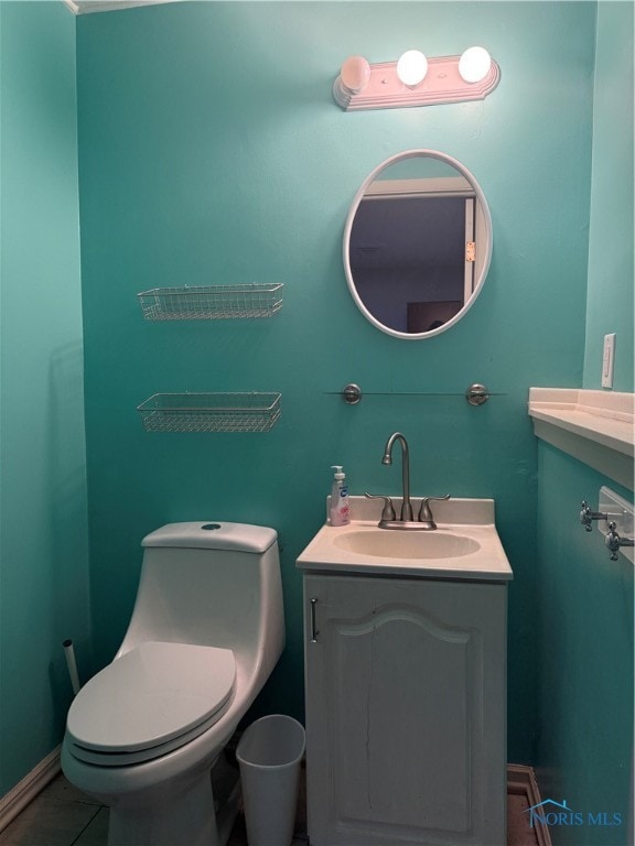 bathroom with vanity, toilet, and tile patterned floors