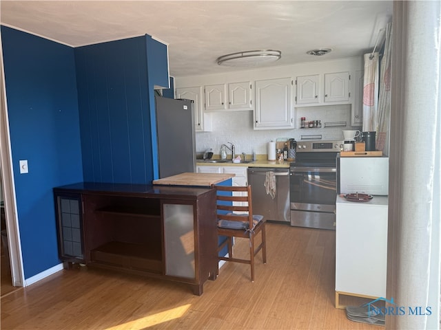 kitchen featuring white cabinetry, light hardwood / wood-style floors, appliances with stainless steel finishes, and sink