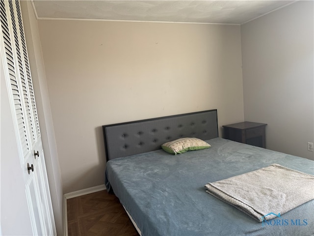 bedroom featuring dark parquet flooring