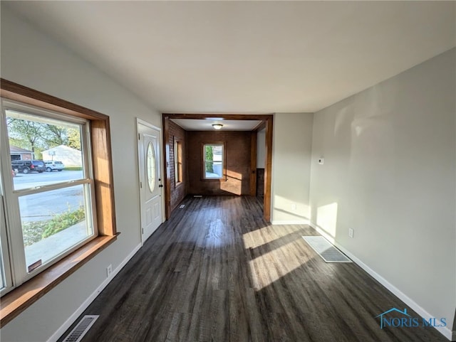 interior space featuring dark hardwood / wood-style flooring and plenty of natural light