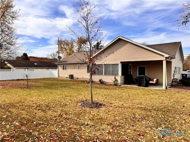 back of house featuring a patio area, central AC, and a lawn