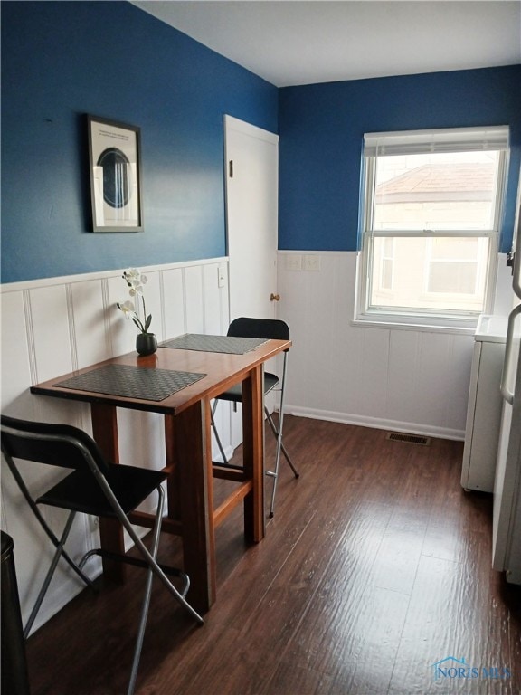 dining area with dark hardwood / wood-style floors