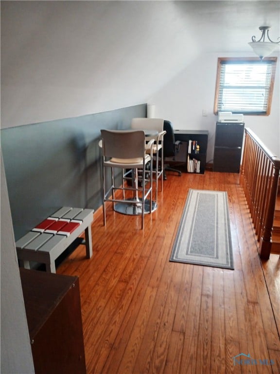 interior space featuring wood-type flooring and vaulted ceiling