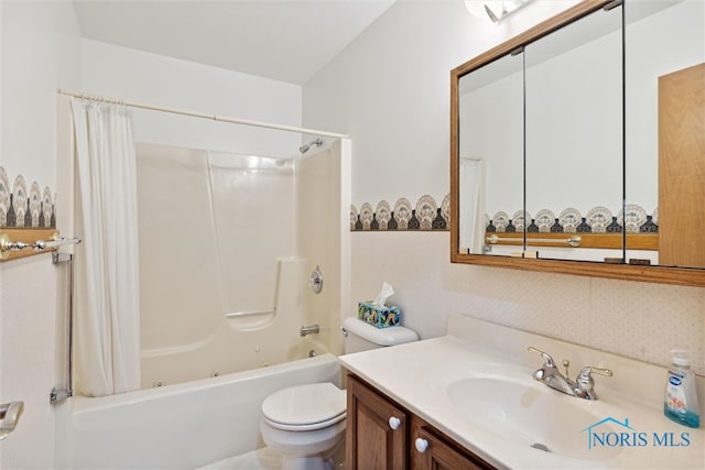 full bathroom featuring vanity, shower / bath combination with curtain, and toilet