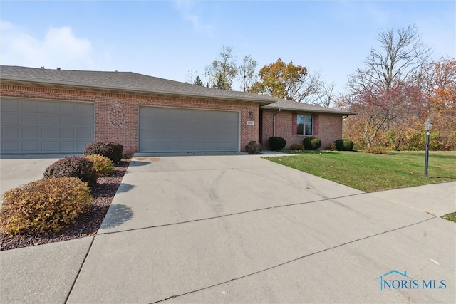 ranch-style home with a front yard and a garage