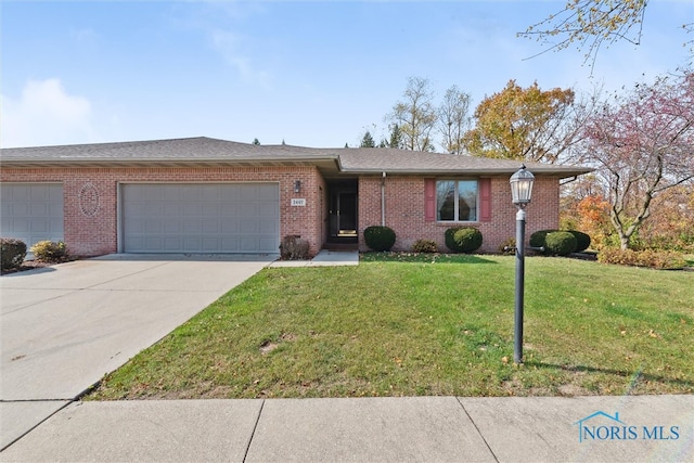 single story home with a front yard and a garage