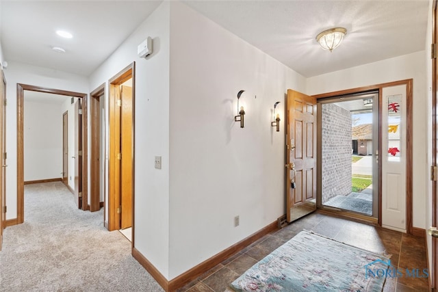 entryway featuring dark carpet