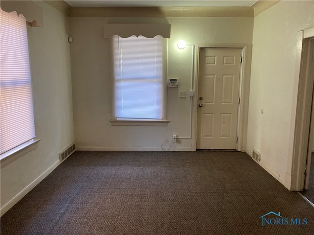 entrance foyer with dark carpet