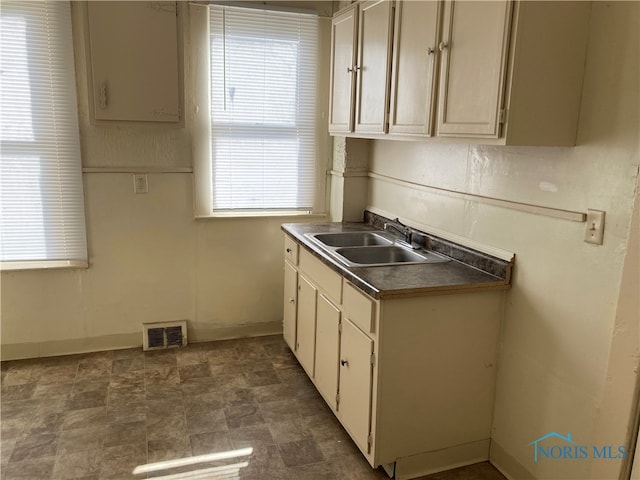 kitchen with sink and cream cabinetry