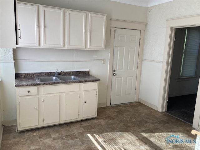 kitchen featuring white cabinets and sink