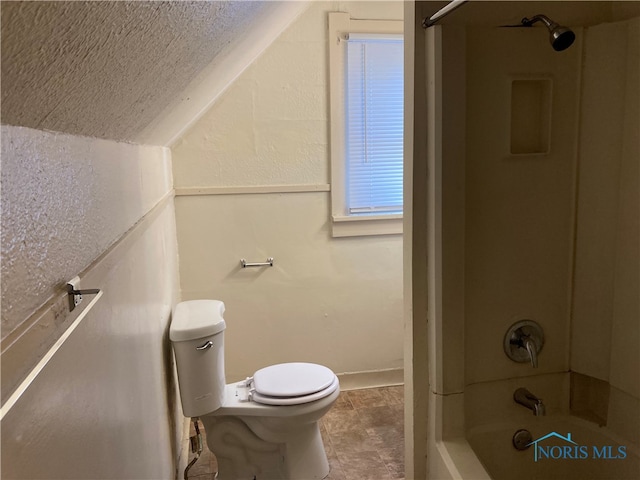 bathroom featuring shower / washtub combination and toilet