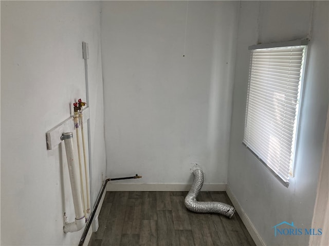 clothes washing area with dark hardwood / wood-style floors