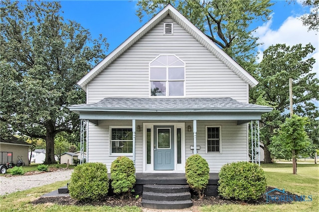 bungalow-style home with a front lawn and covered porch