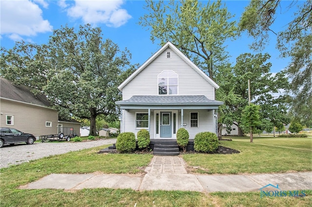 view of front facade featuring a front yard and covered porch