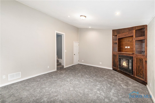 unfurnished living room featuring dark carpet