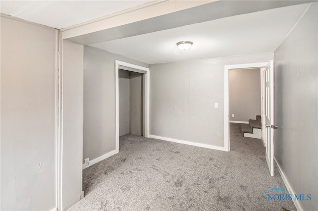 unfurnished bedroom featuring light carpet