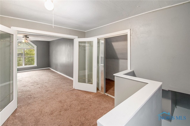 interior space with french doors, carpet, and a textured ceiling