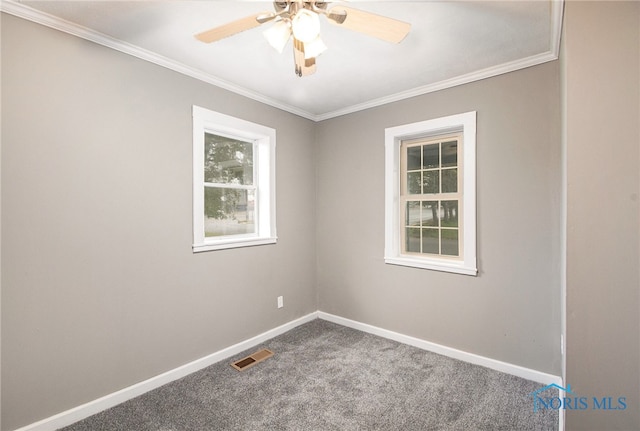 carpeted spare room featuring crown molding and ceiling fan